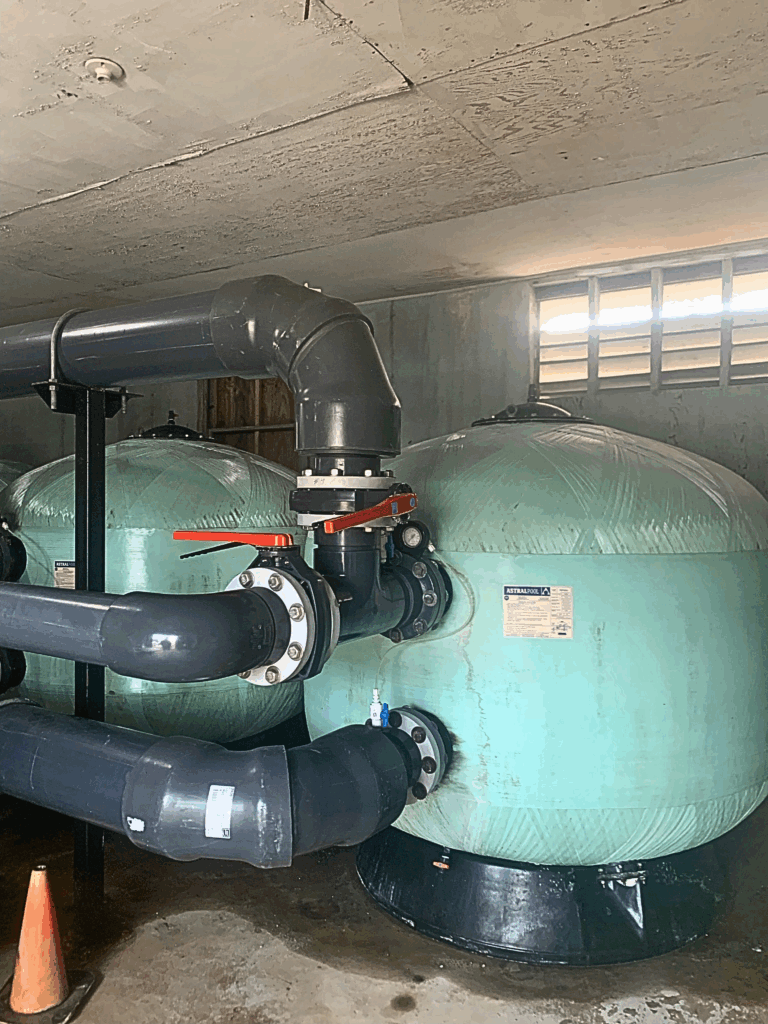 Old pool filters and piping before replacement.