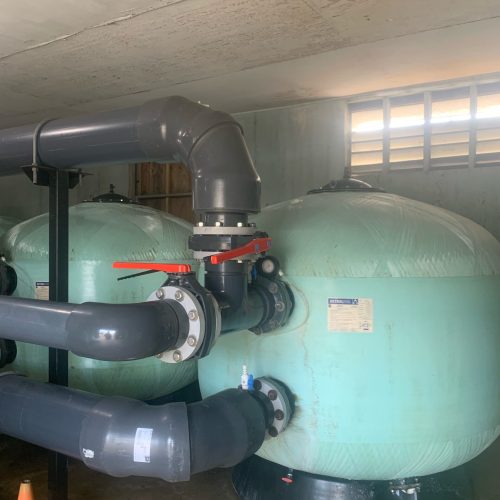 Old pool filters and piping before replacement.